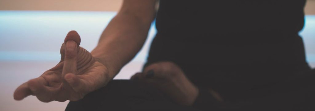 woman sitting down doing meditation