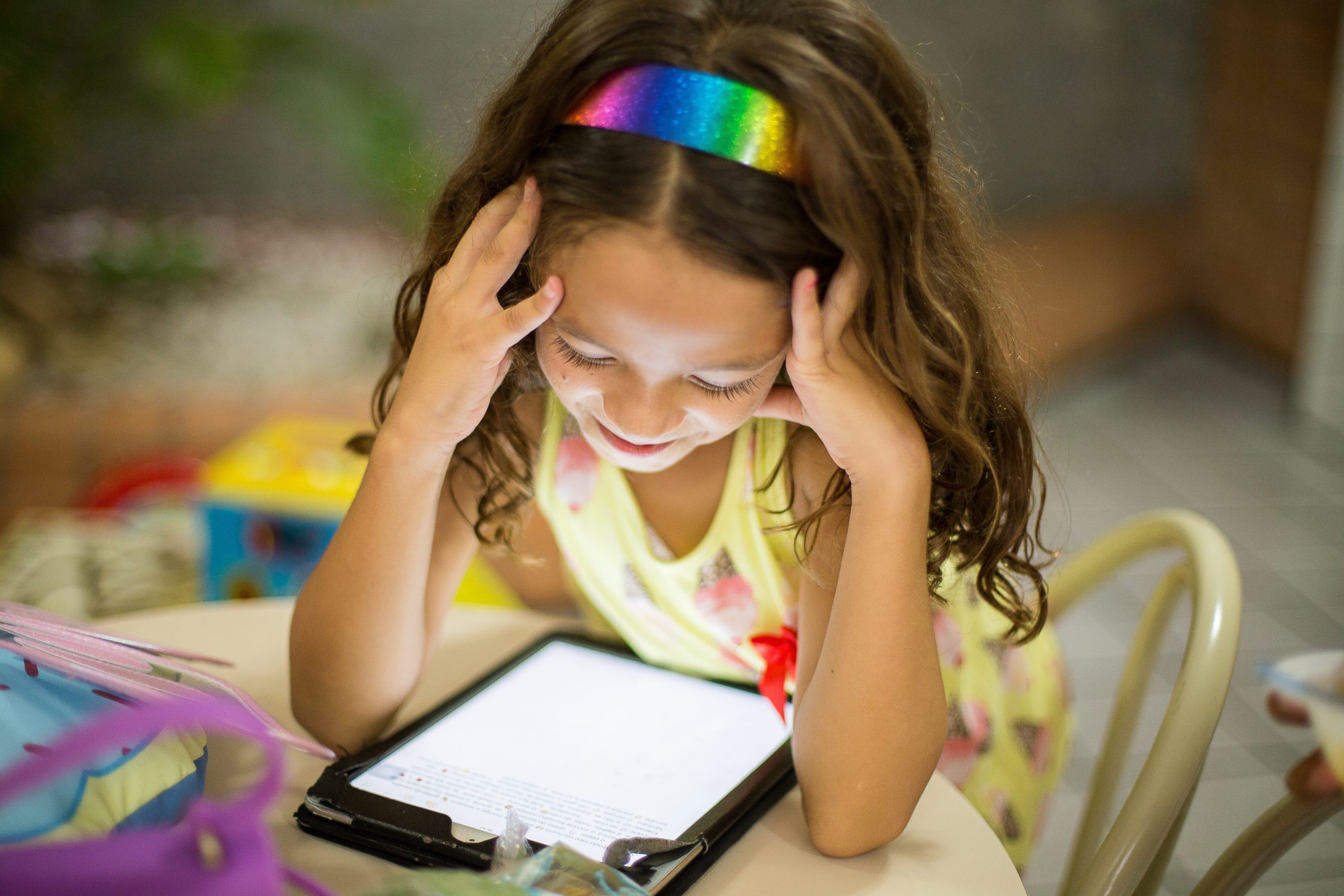 young girl reading on a mobile tablet