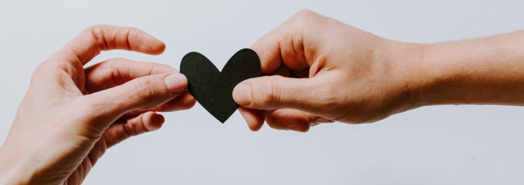 hands holding a paper heart