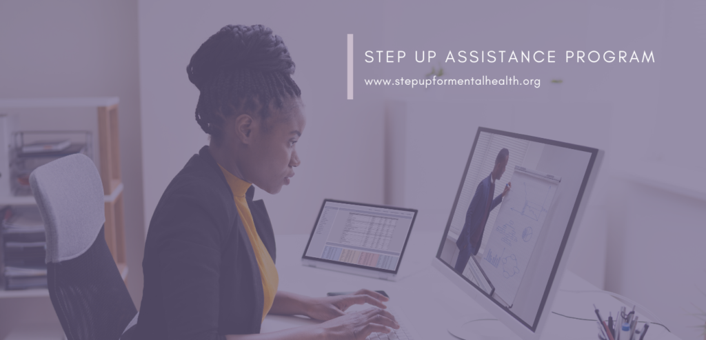 Women at office desk looking at laptop